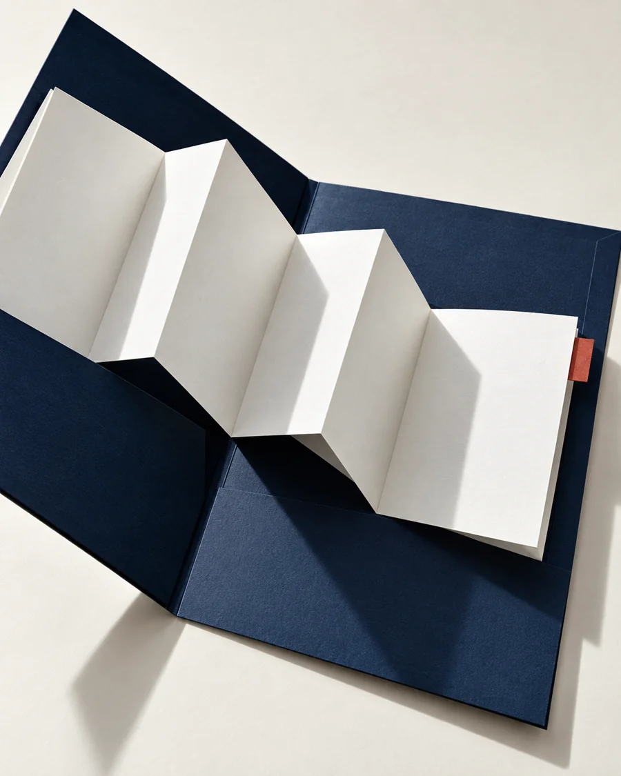 An open navy project folder with a white sheet unfolding across its pages